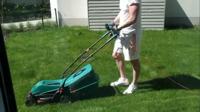 'Video thumbnail for Man At Chores: Mowing Beautiful Green Garden Lawn'