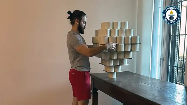 'Video thumbnail for Federico Pavone balances toilet paper rolls on his head for a world record'